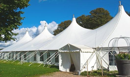 a row of portable restrooms at an outdoor festival, providing comfort and sanitation for attendees in Cheshire